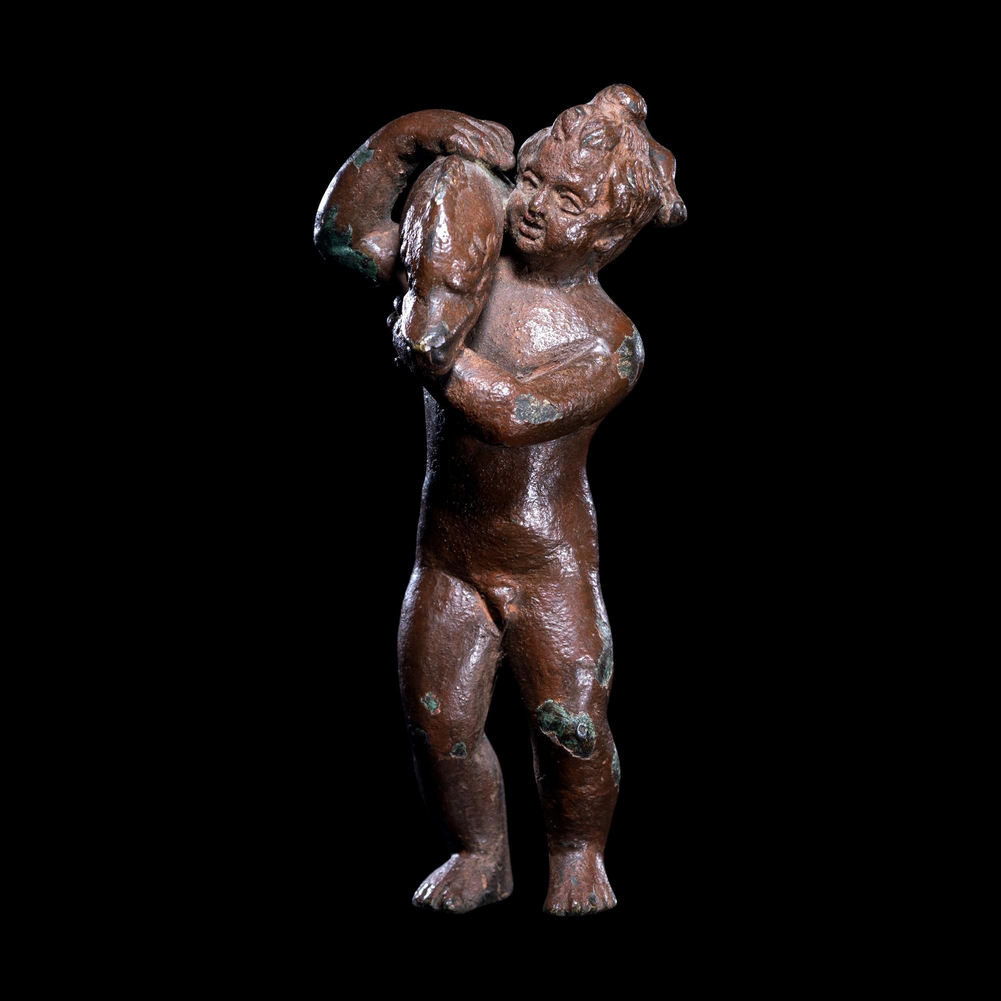 A Roman Bronze Eros with a Dolphin