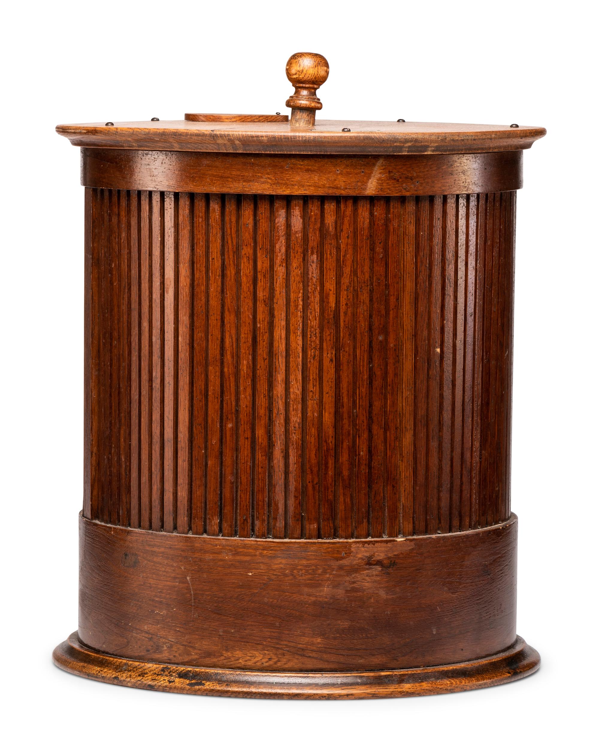 A Merrick's Six Cord Cylindrical Oak Spool Cabinet