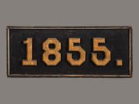 A Carved, Black and Gold Painted Pine Trade Sign
