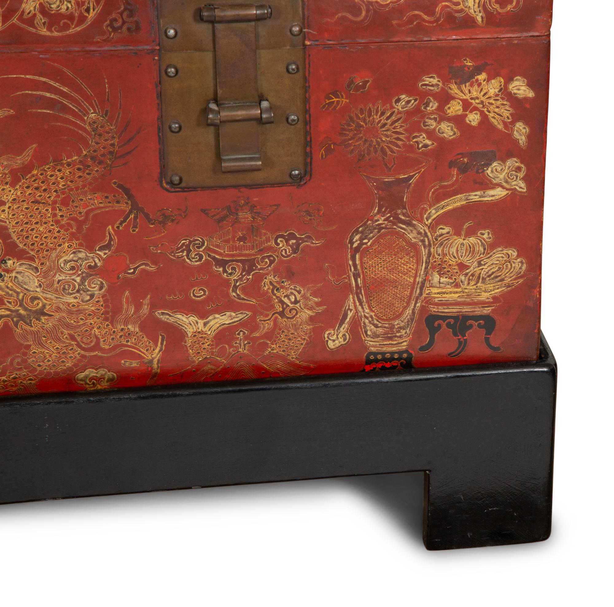 A Chinese Gilt-Decorated Red Leather Trunk on Black Lacquered Stand