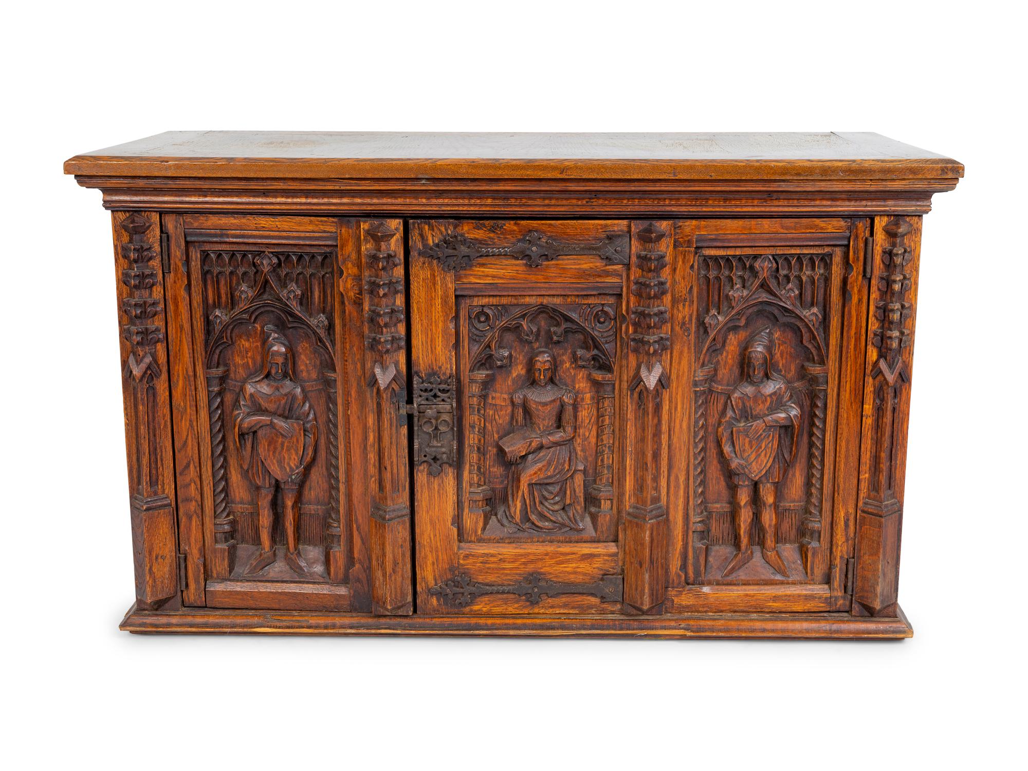 A Renaissance Revival Carved Oak Trunk with Iron Mounts — 19TH/20TH CENTURY