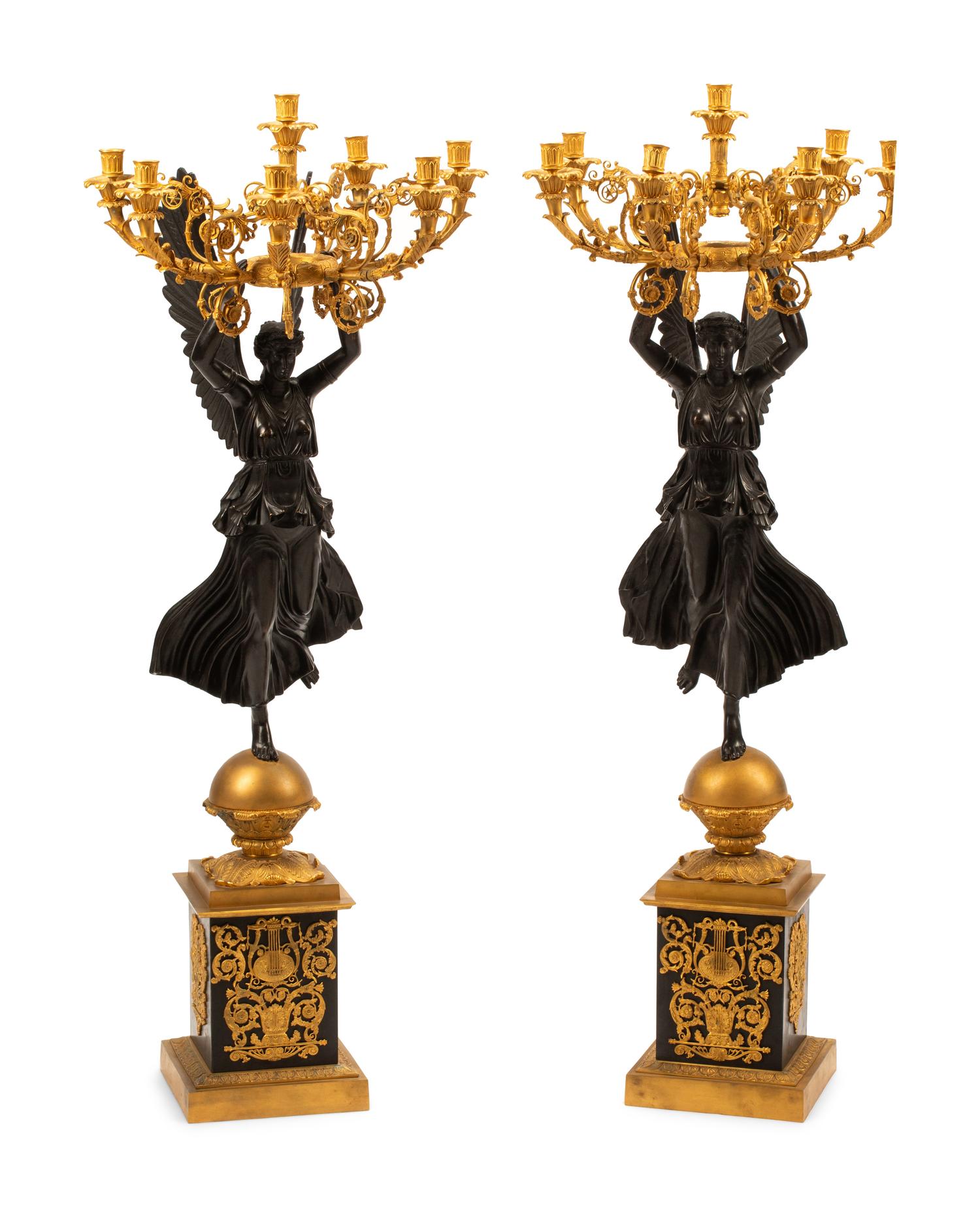 A Pair of Monumental Empire Style Gilt and Patinated Metal Seven-Light Figural Candelabra