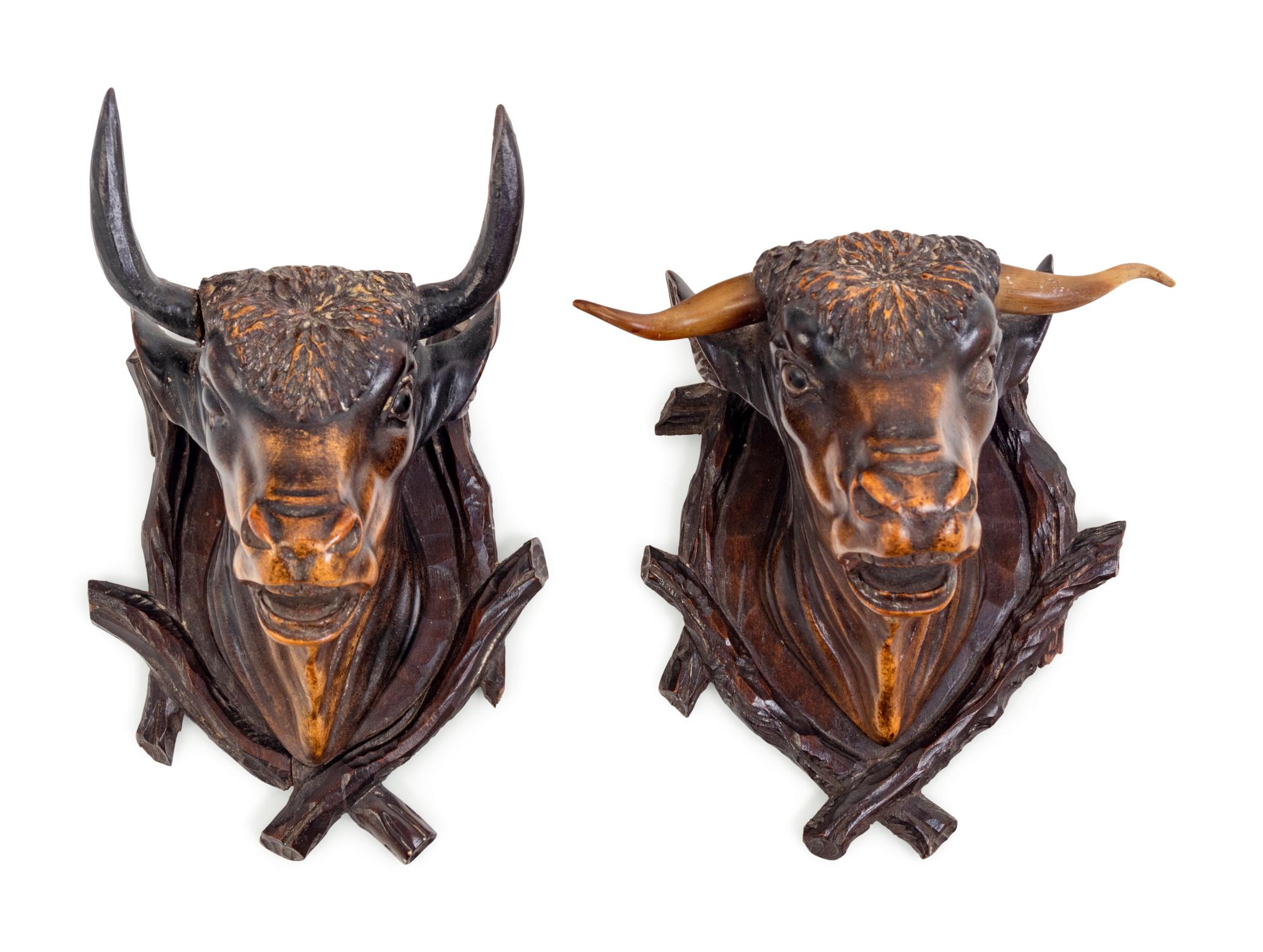 A Pair of Black Forest Carved Wood Bull Wall Mounts