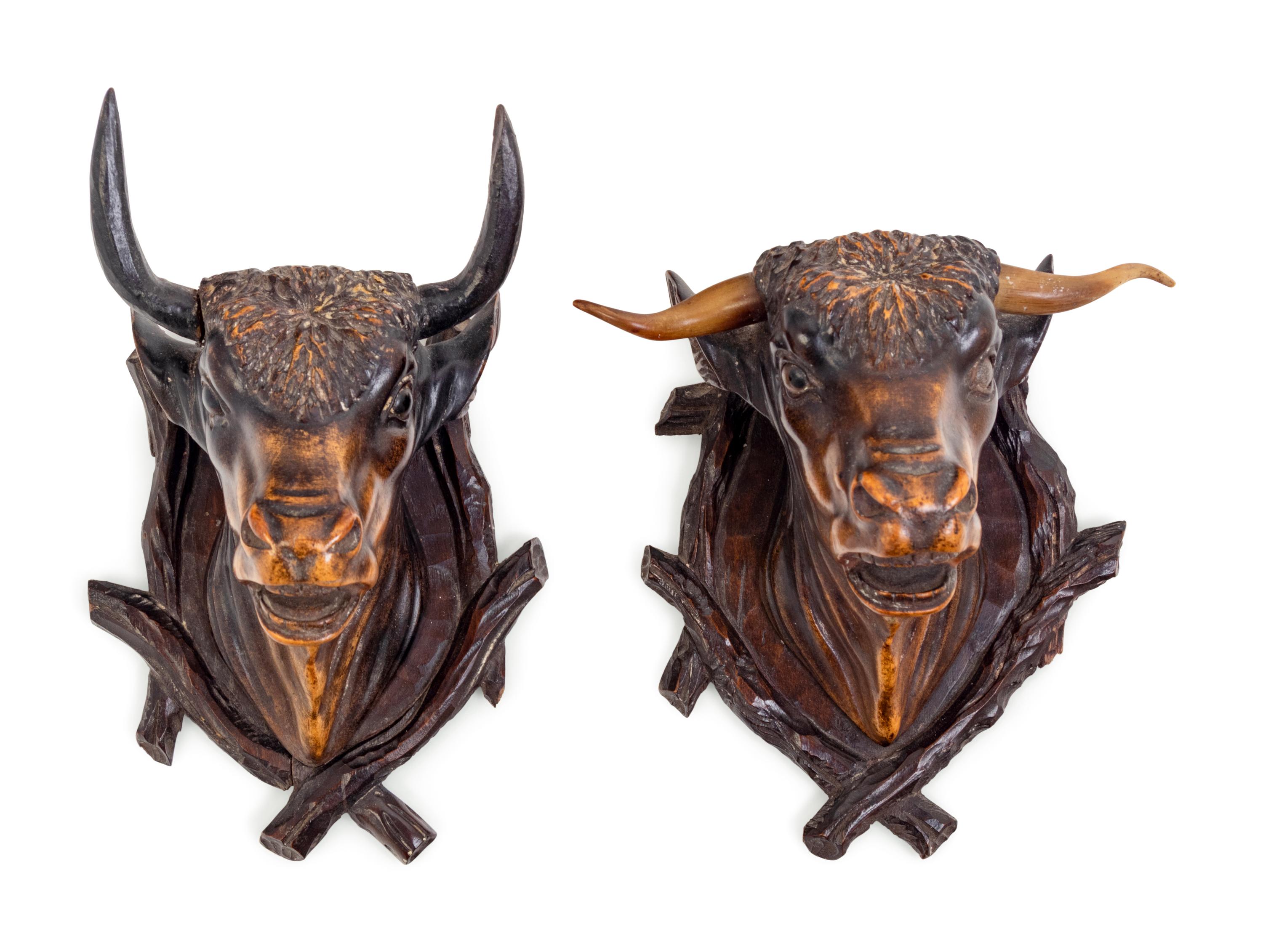A Pair of Black Forest Carved Wood Bull Wall Mounts