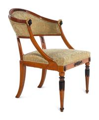 A Pair of Empire Style Parcel Gilt and Ebonized Bergères
