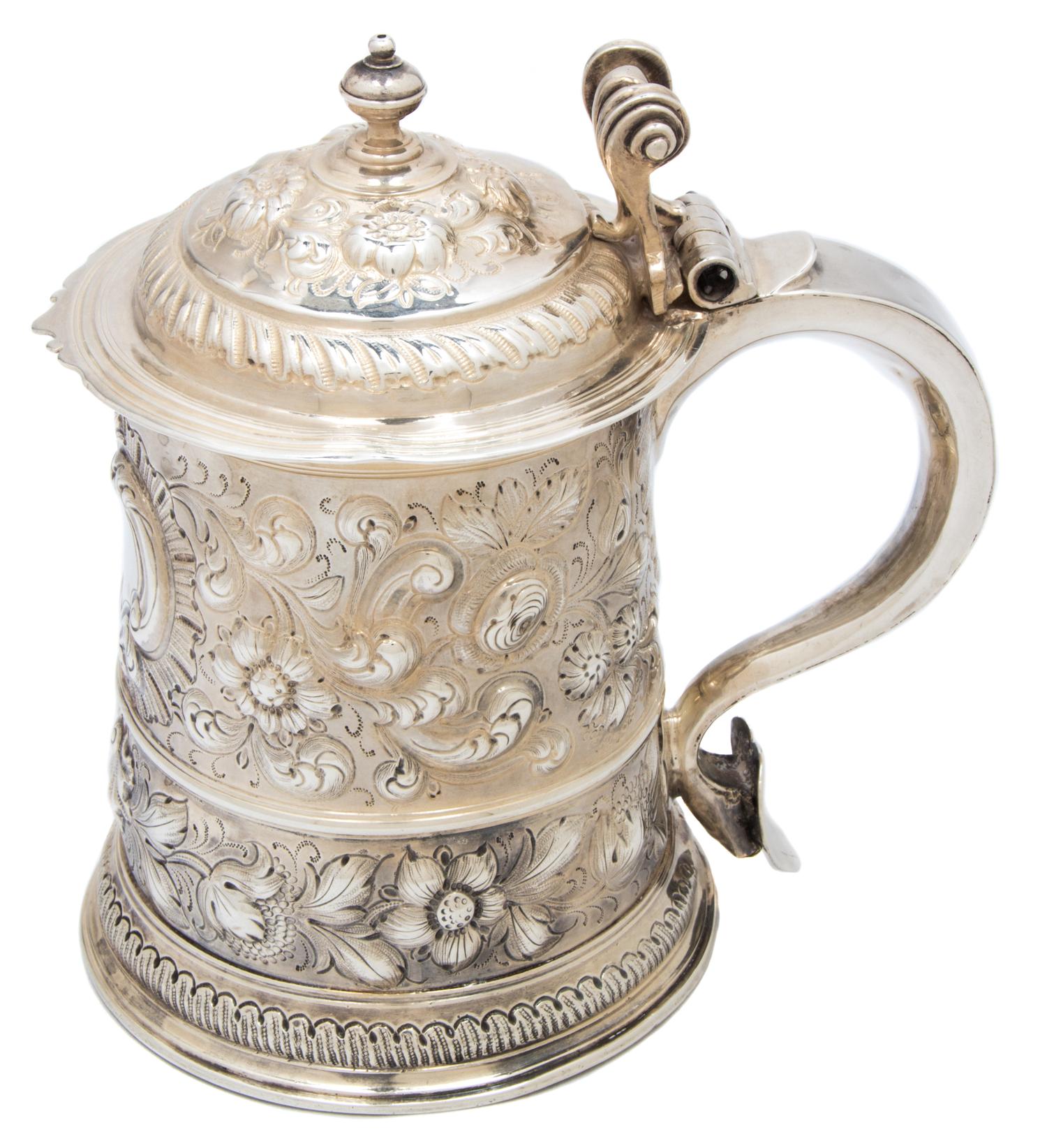 A Queen Anne Silver Tankard, London, 1706, having repousse floral and shell decoration and a triple scroll thumb piece, maker's mark il