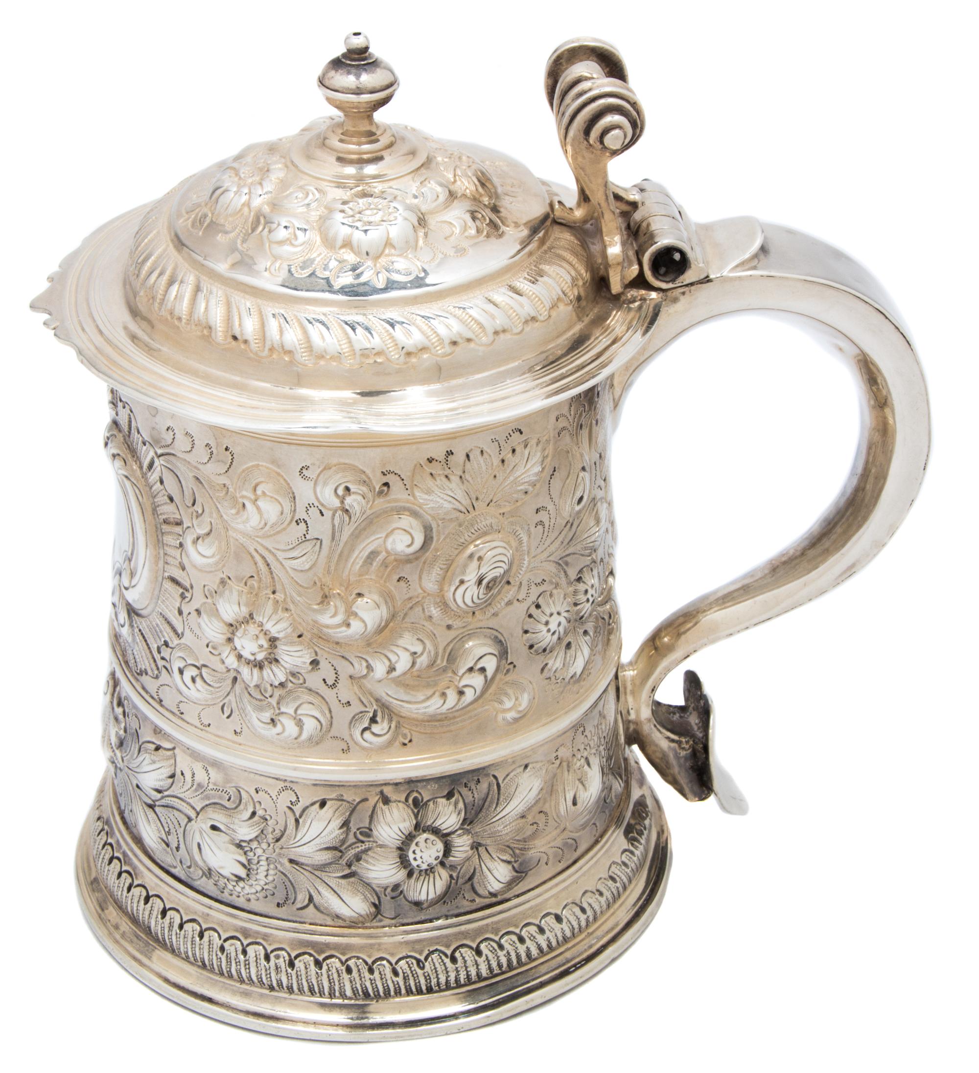 A Queen Anne Silver Tankard, London, 1706, having repousse floral and shell decoration and a triple scroll thumb piece, maker's mark il