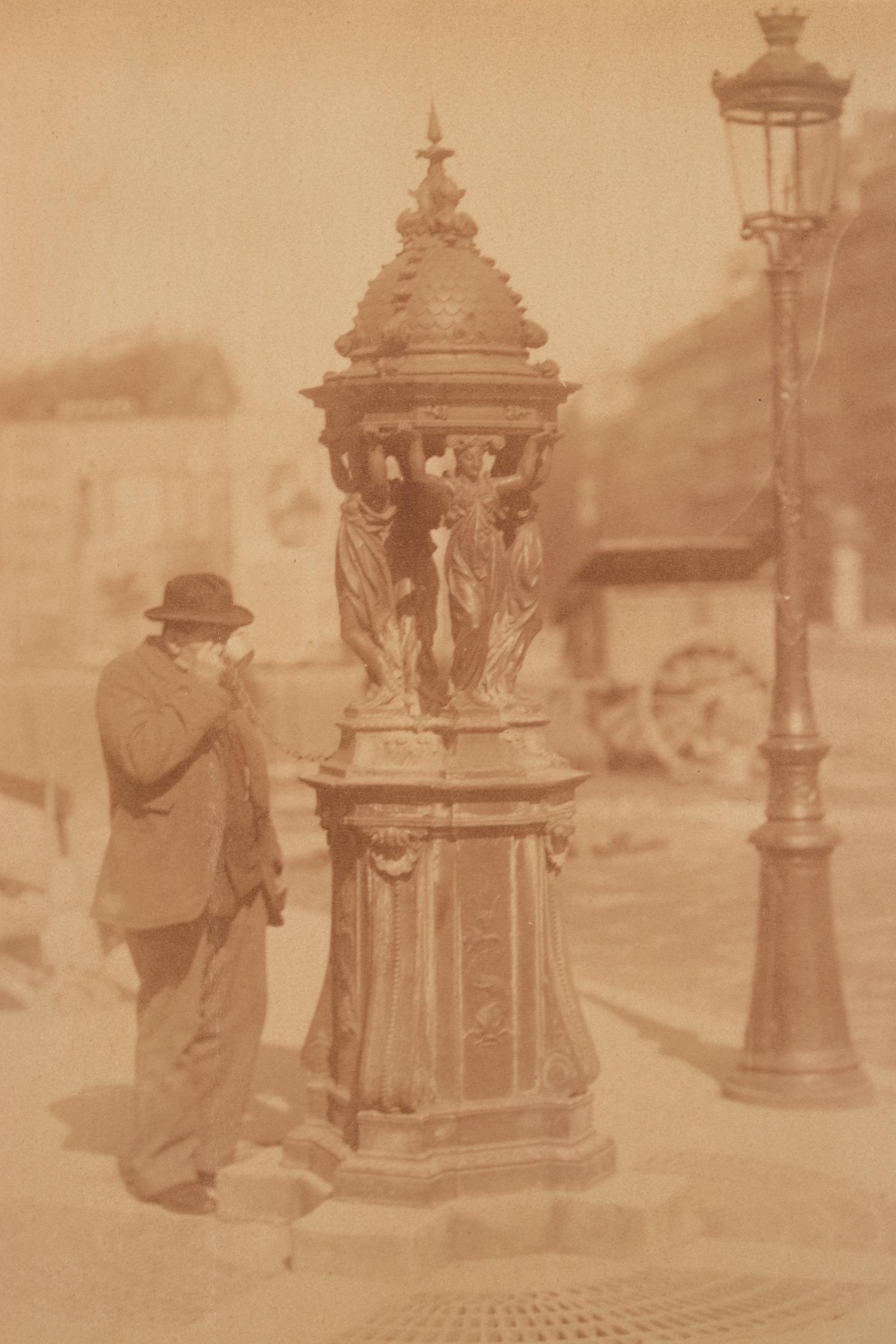 A group of four photographs ( Untitled [man at fountain], circa 1900s; Boutique empire, 14 rue de Grammont , 1903-1904; Hôtel de Neuville, rue Alphonse de Neuville, 1905-1906; Fontaine, faubourg Saint-Martin, 1912)