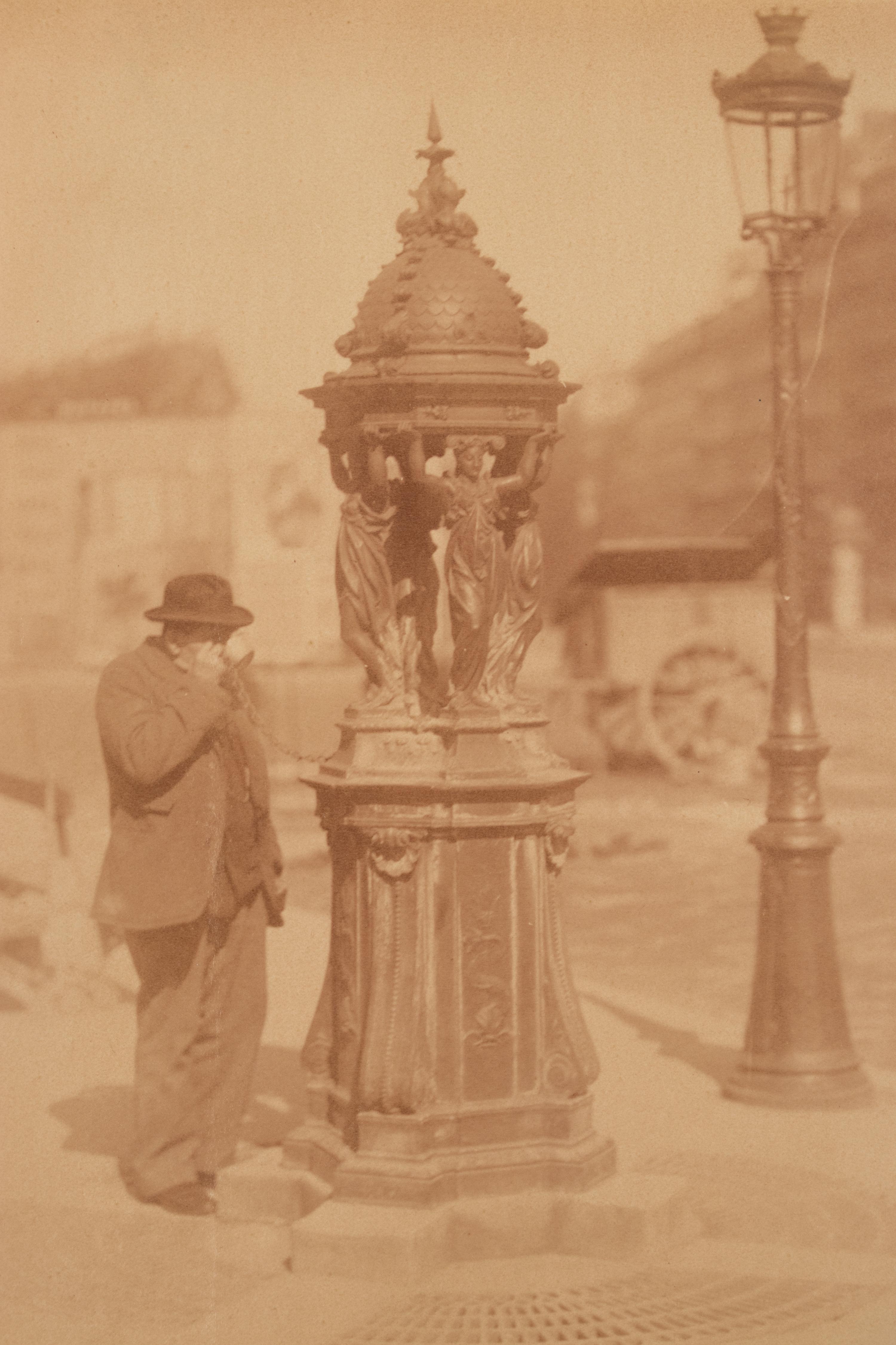 A group of four photographs ( Untitled [man at fountain], circa 1900s; Boutique empire, 14 rue de Grammont , 1903-1904; Hôtel de Neuville, rue Alphonse de Neuville, 1905-1906; Fontaine, faubourg Saint-Martin, 1912)
