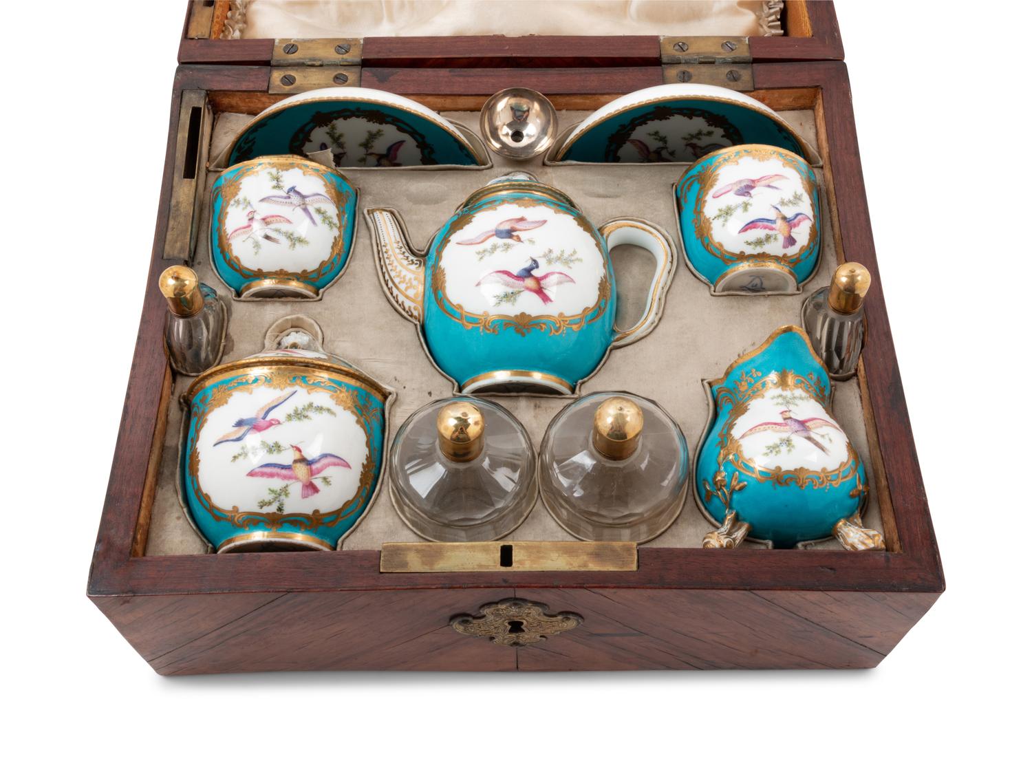 A Sèvres Painted and Parcel Gilt Porcelain Tea and Cordial Service in a Fitted Kingwood and Parquetry Traveling Case
