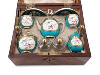 A Sèvres Painted and Parcel Gilt Porcelain Tea and Cordial Service in a Fitted Kingwood and Parquetry Traveling Case