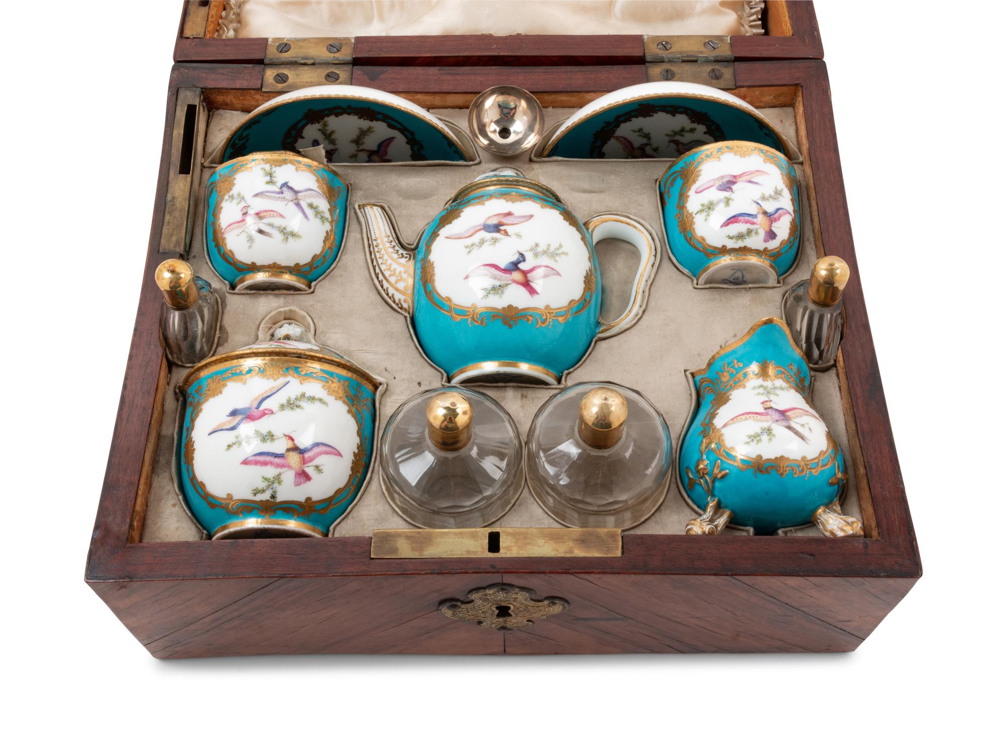 A Sèvres Painted and Parcel Gilt Porcelain Tea and Cordial Service in a Fitted Kingwood and Parquetry Traveling Case