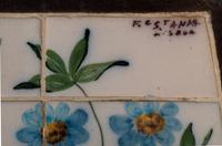 A Wrought Iron and Tile Bench and Pair of Chairs
