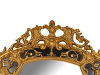 A Large Rococo Style Ebonized Parcel Gilt Pier Mirror