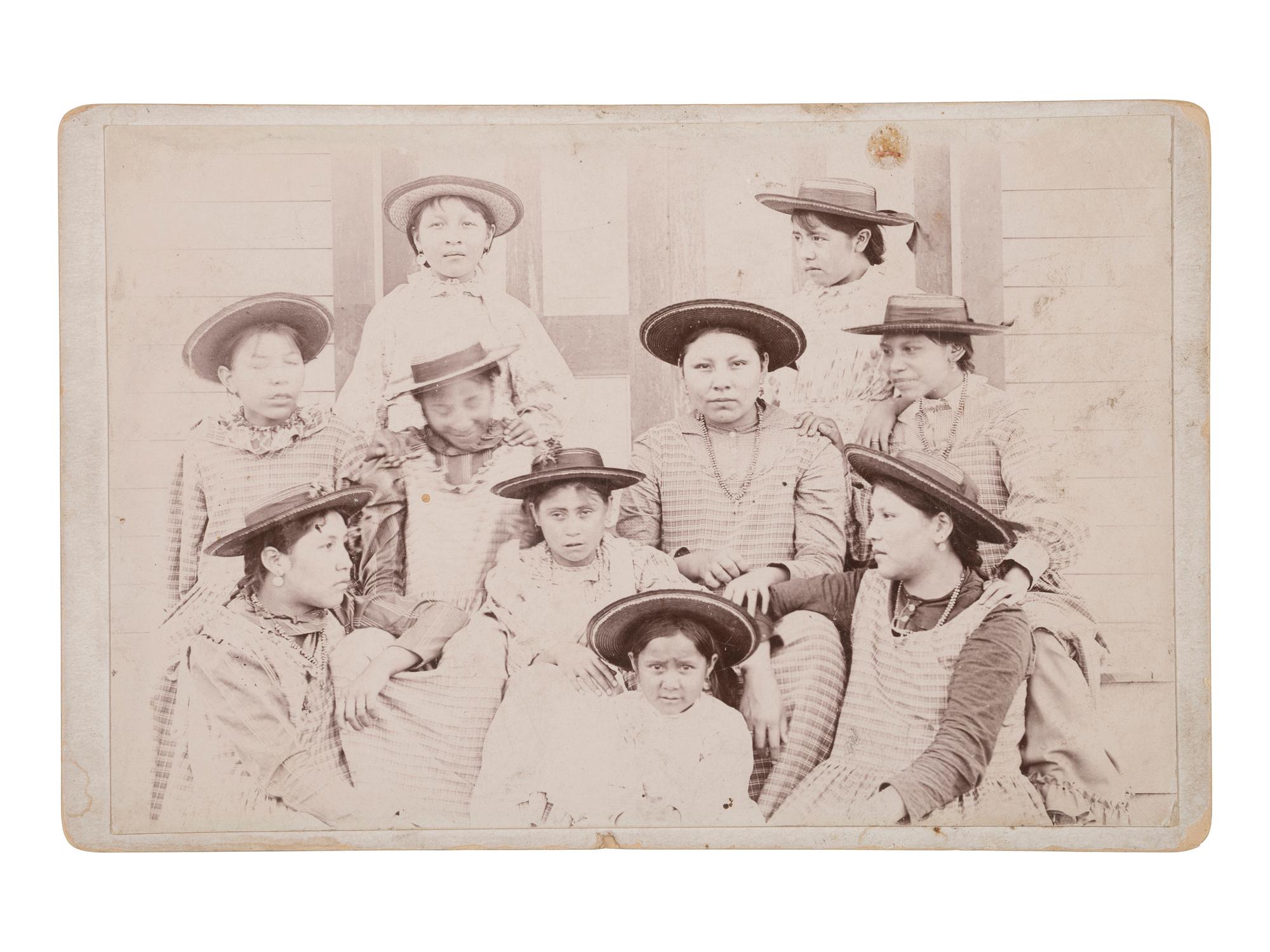[NATIVE AMERICANS]. Cabinet card of female Indian School students with ledger drawing on verso.
