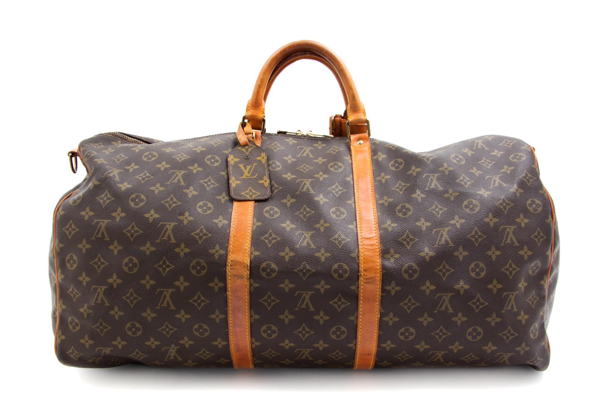 A Louis Vuitton Monogram Canvas Duffle Bag, 24" x 12" x 10.5".