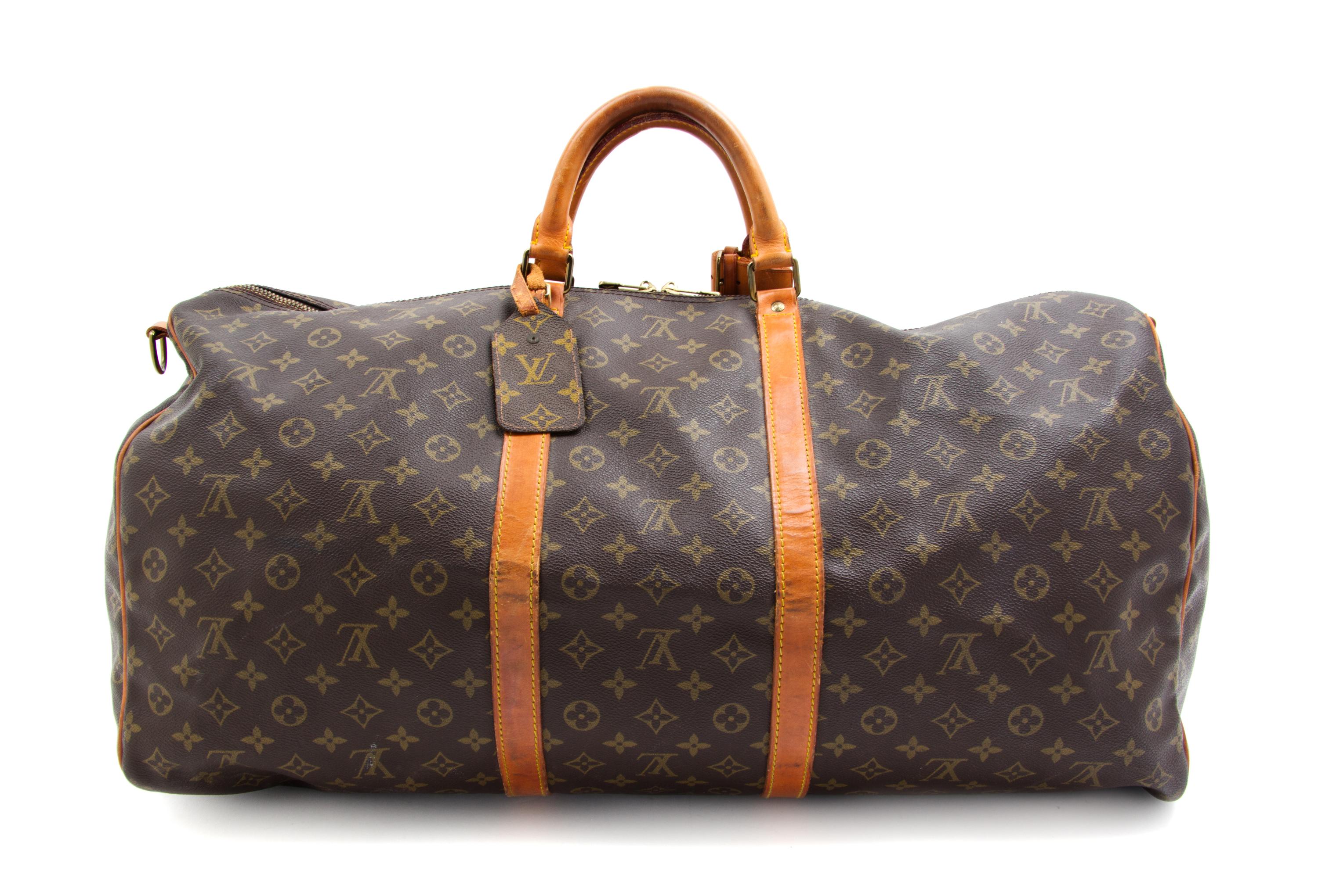 A Louis Vuitton Monogram Canvas Duffle Bag, 24" x 12" x 10.5".