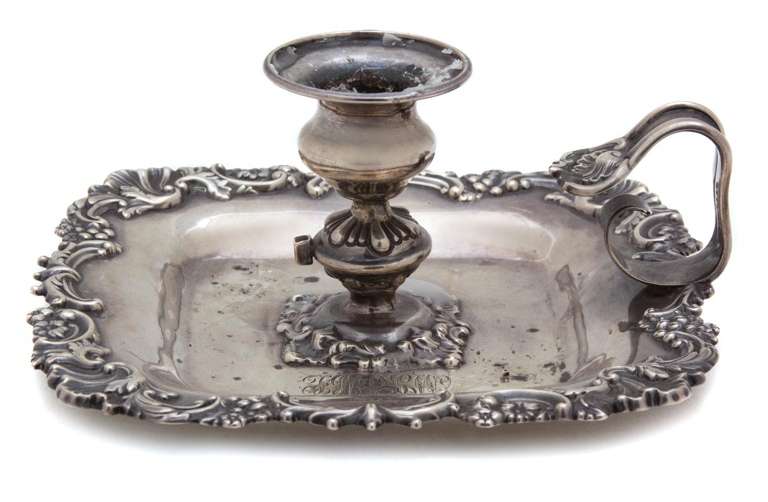 An American Silver Candle Holder, Howard & Co., New York, NY, 19th Century, having a shell and c-scroll border, loop handle, monogramme