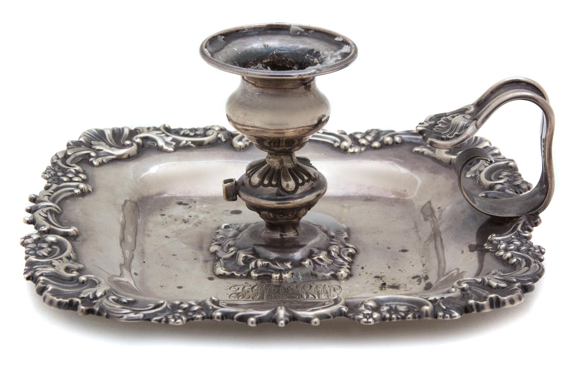 An American Silver Candle Holder, Howard & Co., New York, NY, 19th Century, having a shell and c-scroll border, loop handle, monogramme
