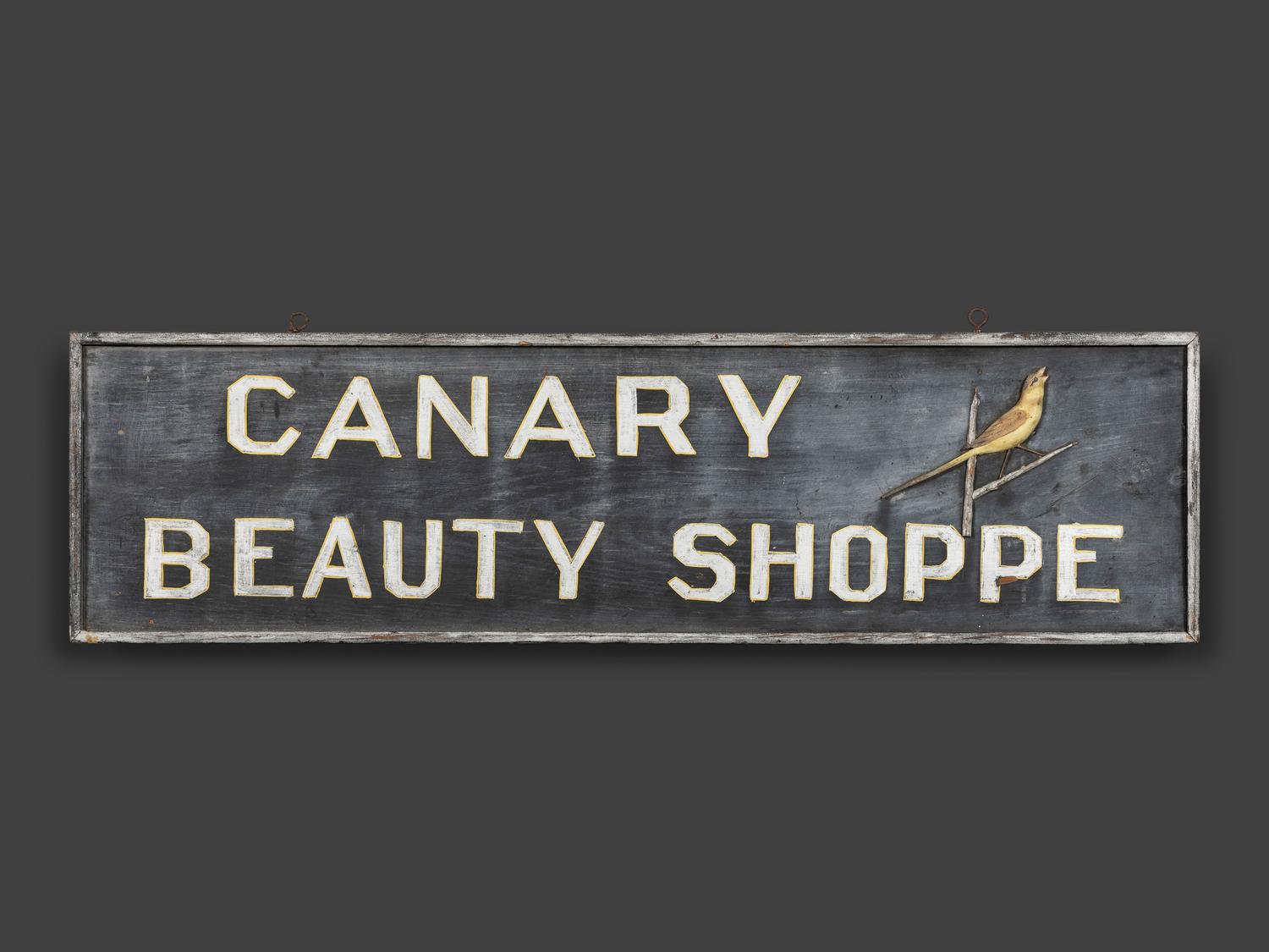 A Canary Beauty Shoppe Painted Wood Double-Sided Sign