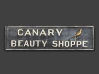 A Canary Beauty Shoppe Painted Wood Double-Sided Sign