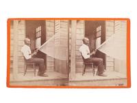 [EARLY PHOTOGRAPHY]. WILSON & HAVENS, photographers. Stereoview of African American man repairing a net.