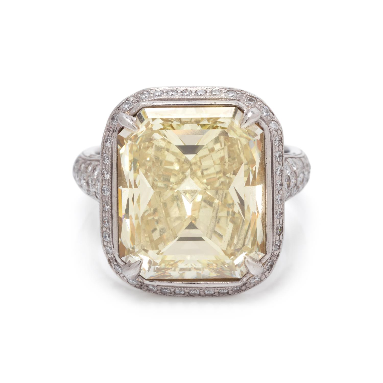 AN IMPRESSIVE FANCY YELLOW DIAMOND AND DIAMOND RING