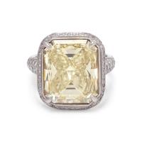 AN IMPRESSIVE FANCY YELLOW DIAMOND AND DIAMOND RING