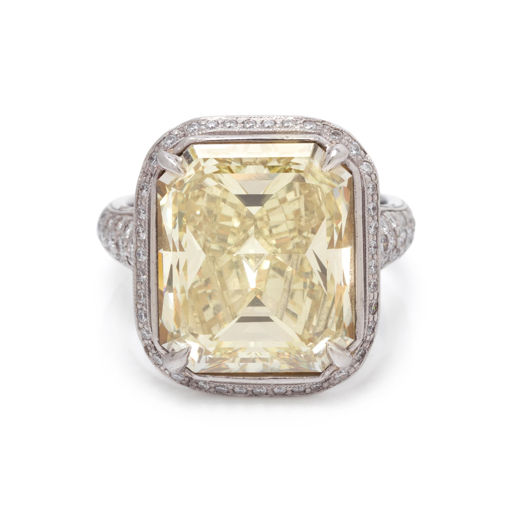 AN IMPRESSIVE FANCY YELLOW DIAMOND AND DIAMOND RING
