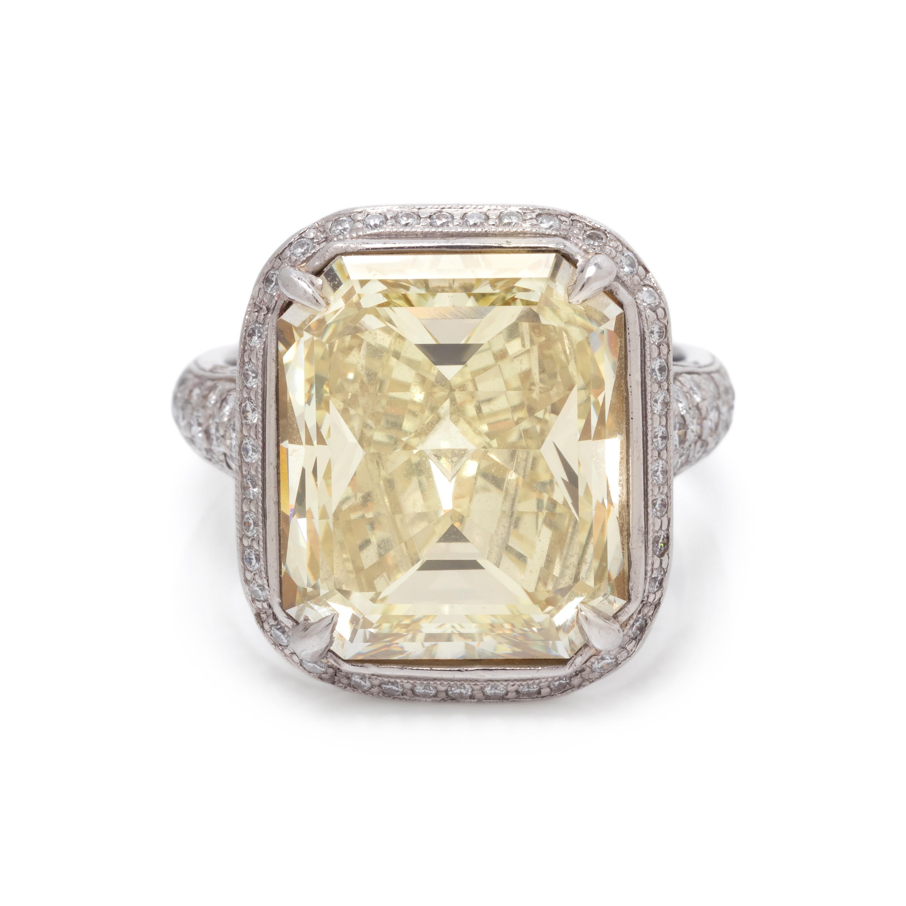 AN IMPRESSIVE FANCY YELLOW DIAMOND AND DIAMOND RING