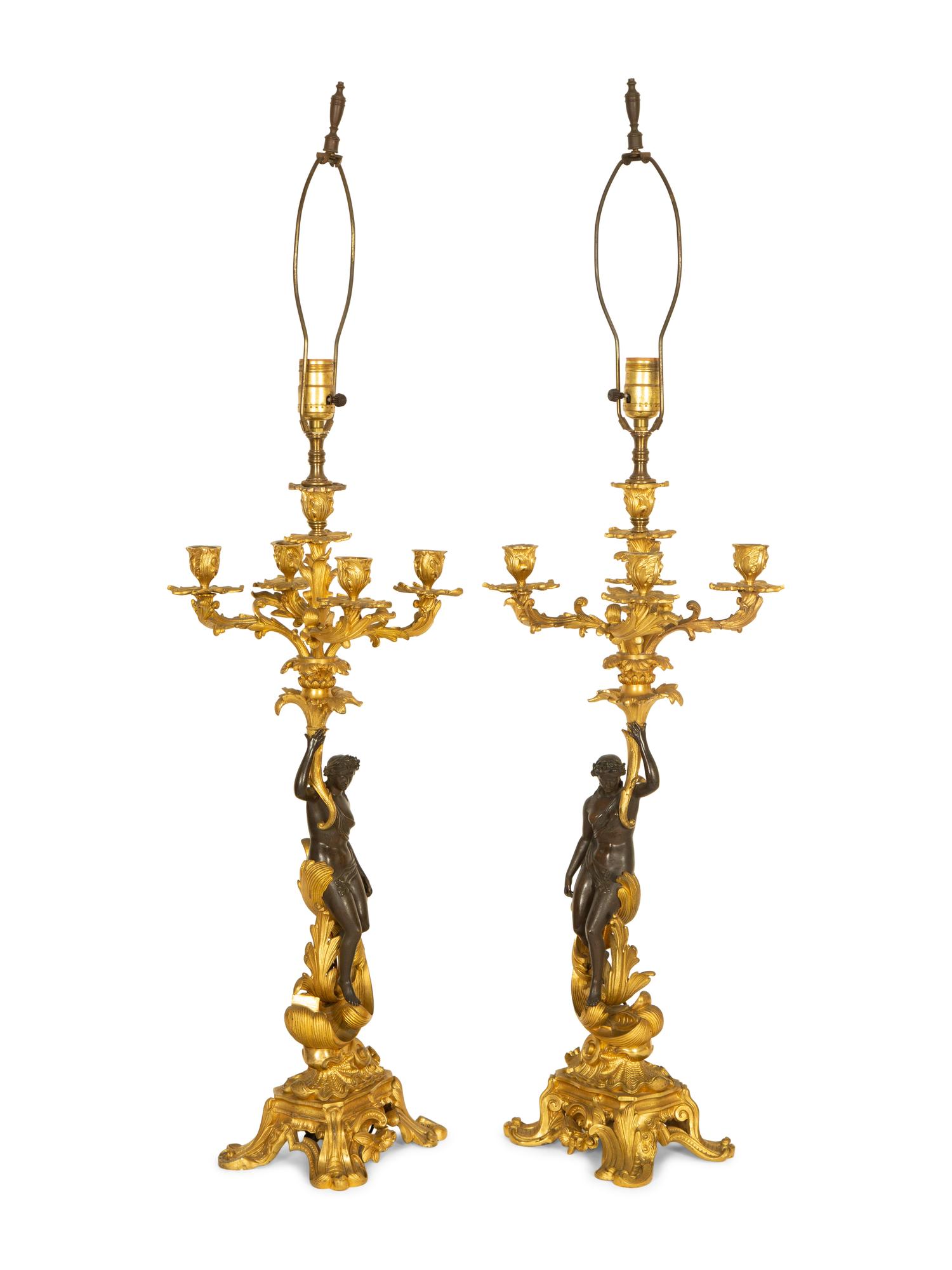 A Pair of Patinated and Gilt Bronze Figural Five-Light Candelabra Mounted as Lamps
