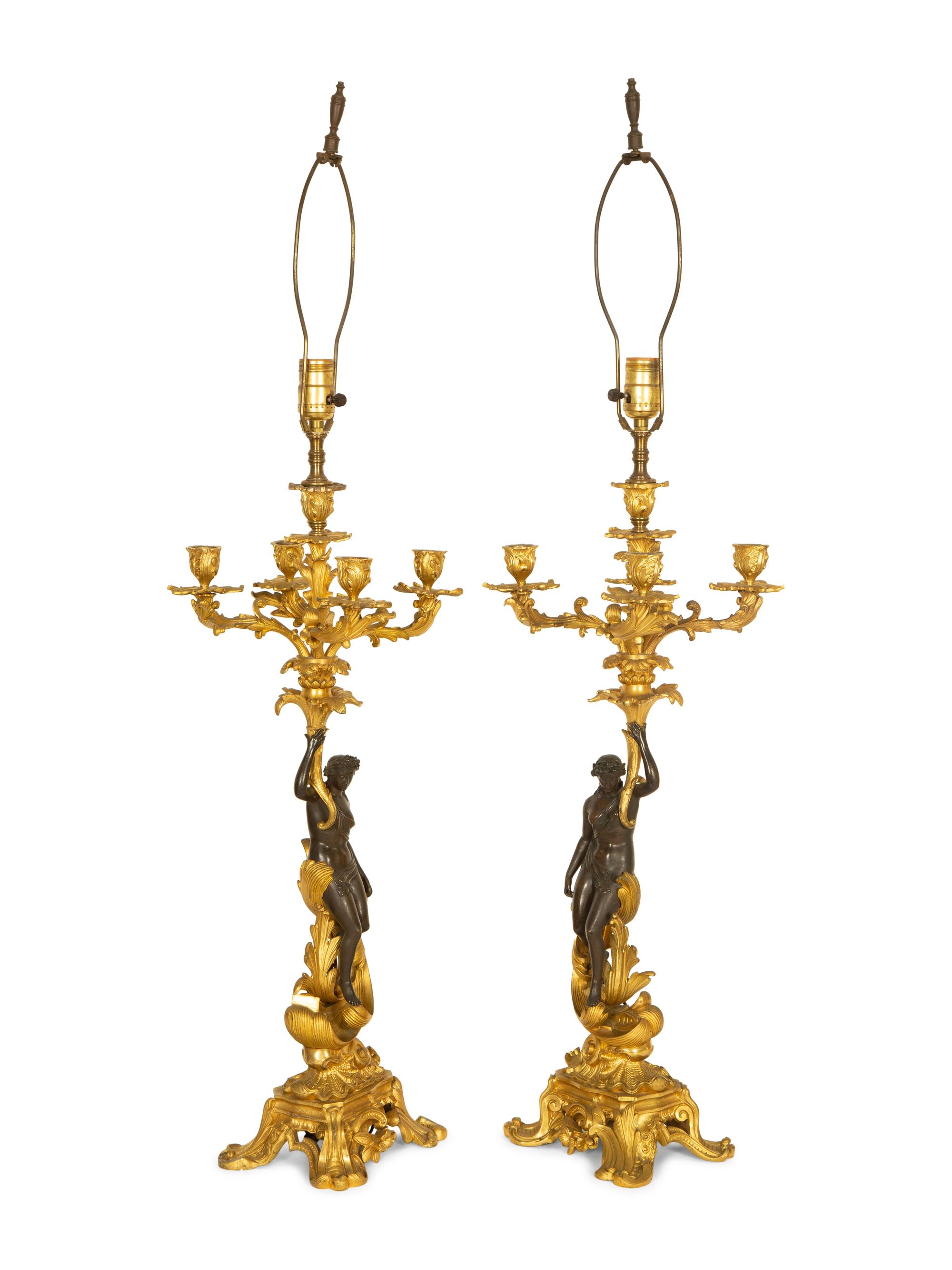 A Pair of Patinated and Gilt Bronze Figural Five-Light Candelabra Mounted as Lamps
