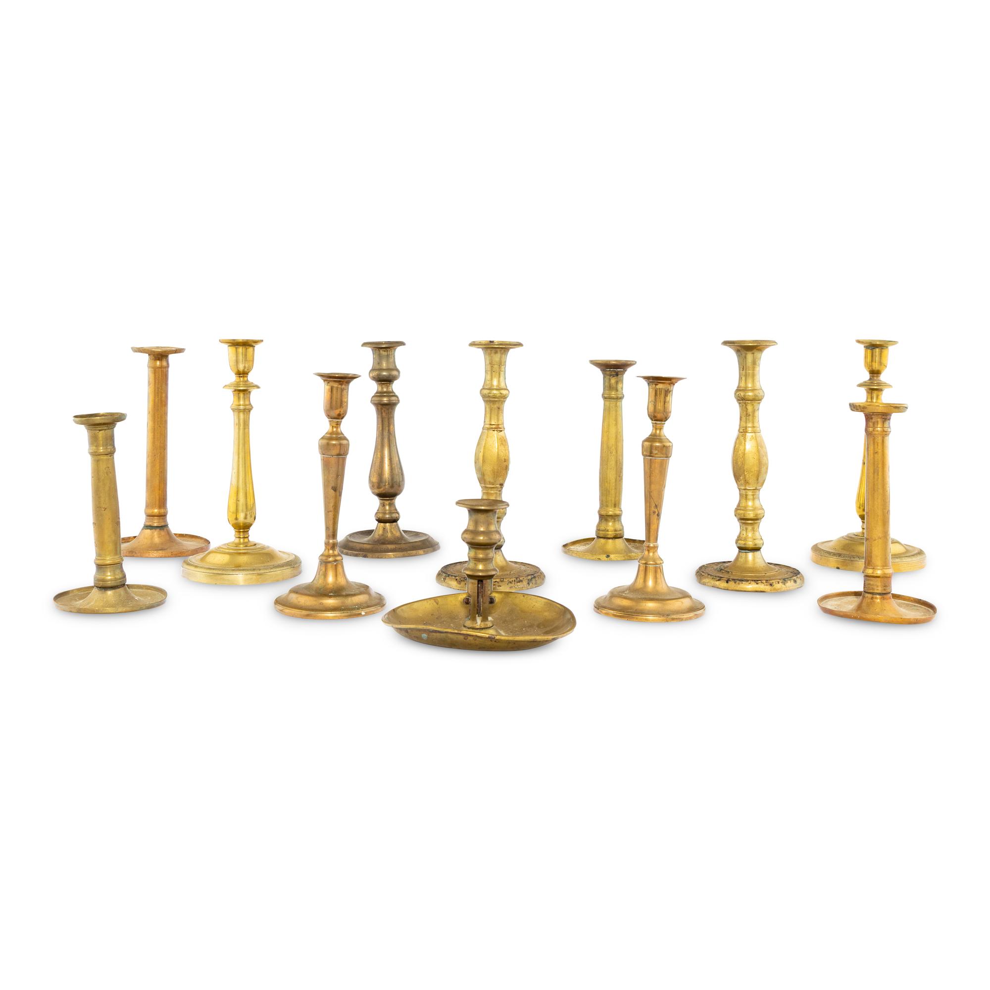 A Collection of Twelve Brass Candlesticks