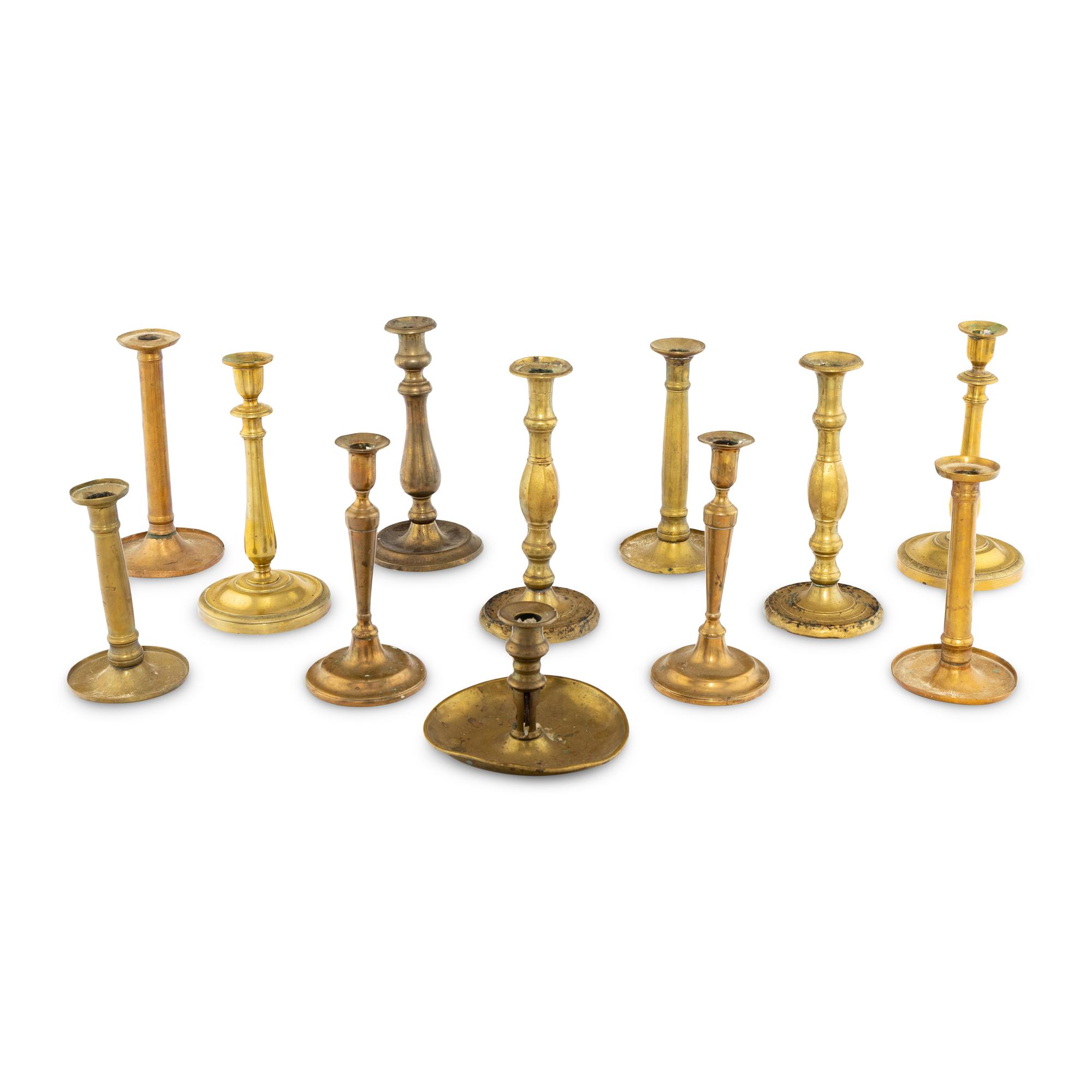 A Collection of Twelve Brass Candlesticks