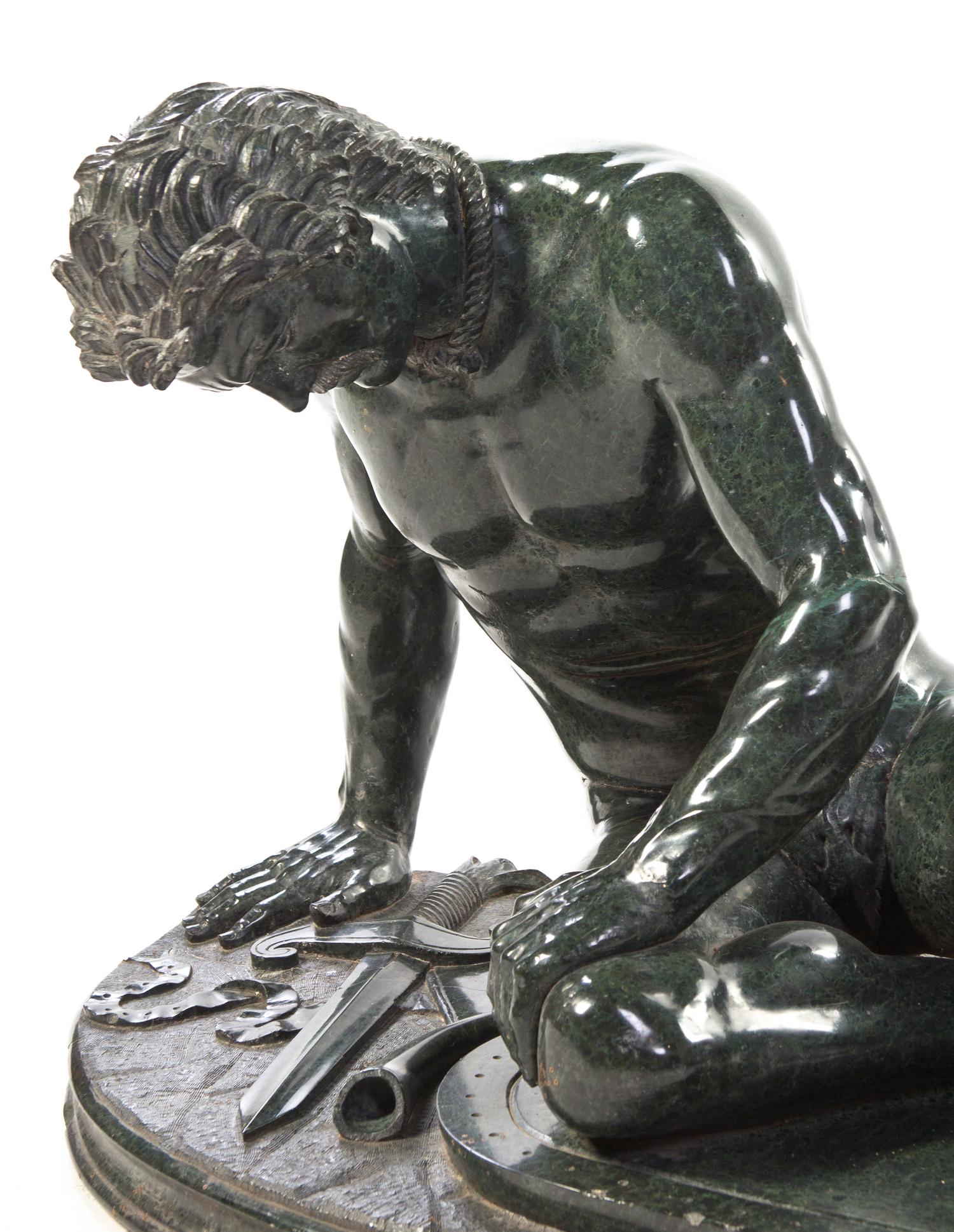 A Continental Carved Marble Figure, after the Antique, Width overall 41 inches.