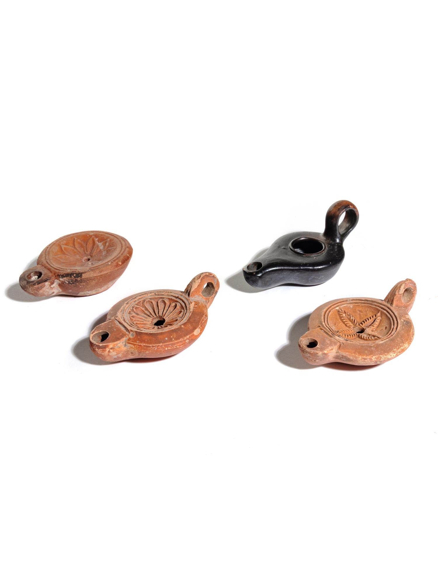 Four Roman Molded Terra Cotta Oil Lamps