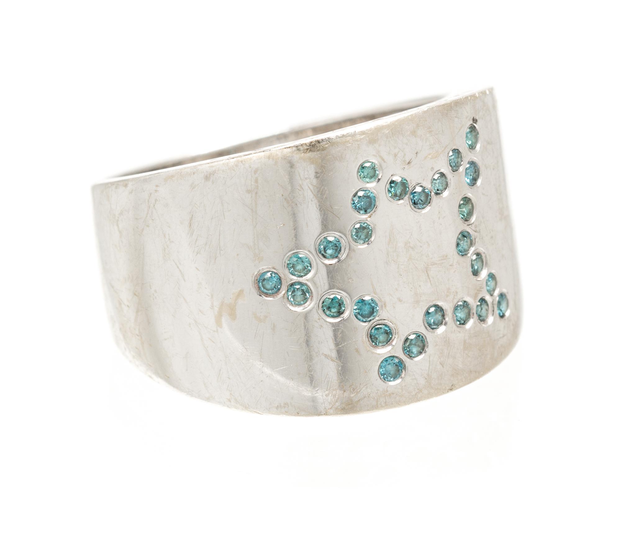 An 18 Karat White Gold and Colored Diamond Star Motif Ring, 4.30 dwts.