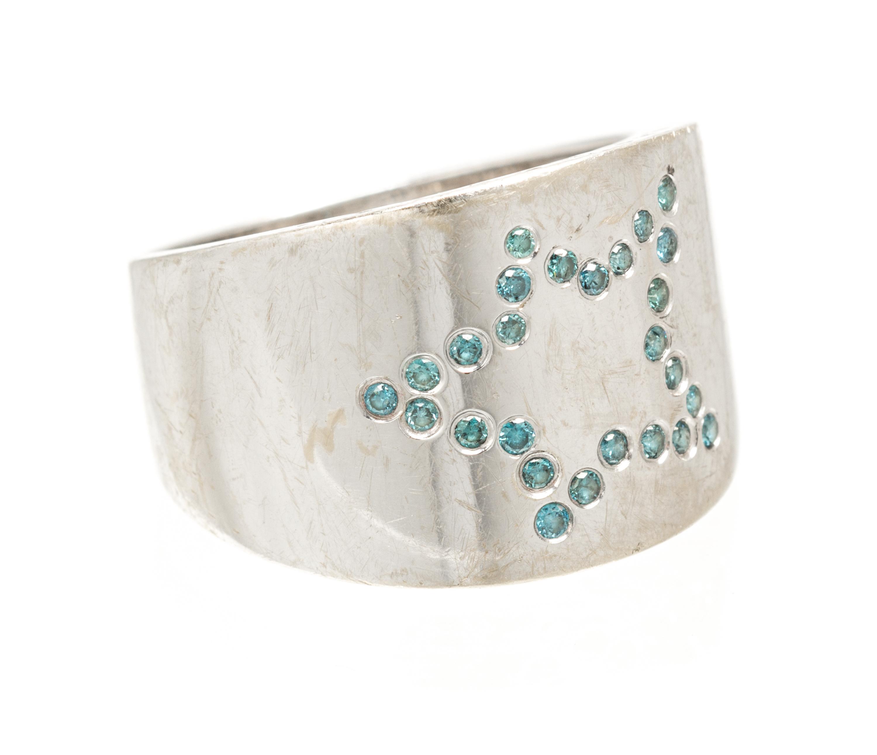An 18 Karat White Gold and Colored Diamond Star Motif Ring, 4.30 dwts.
