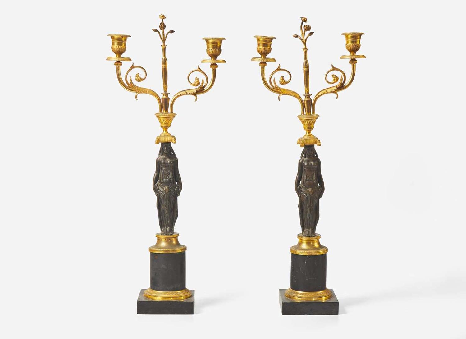 A pair of French Empire gilt and patinated bronze candelabras, first quarter 19th century