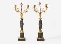 A pair of French Empire gilt and patinated bronze candelabras, first quarter 19th century