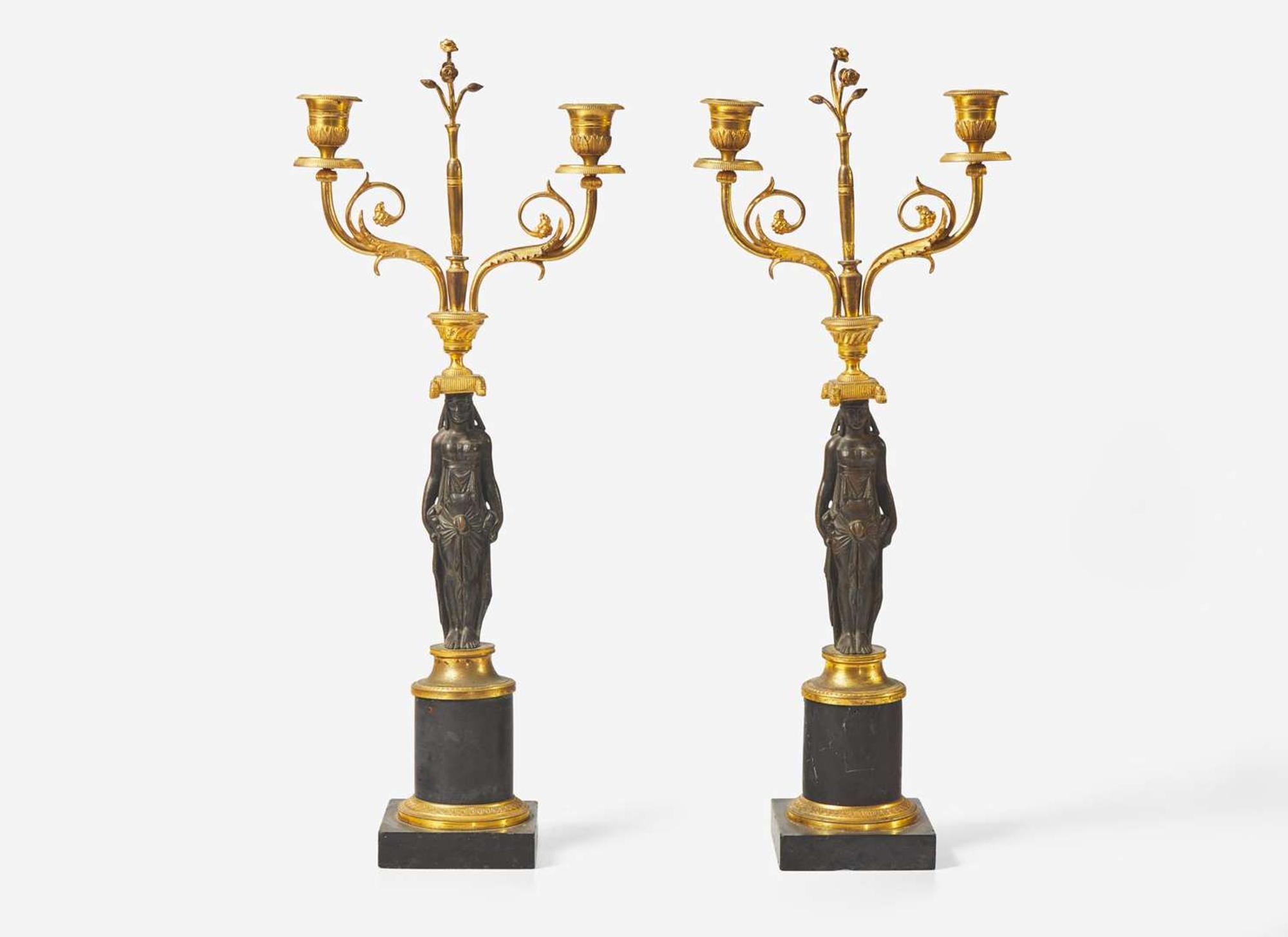 A pair of French Empire gilt and patinated bronze candelabras, first quarter 19th century