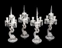 A Set of Four Baccarat Dauphin Three-Light Candelabra