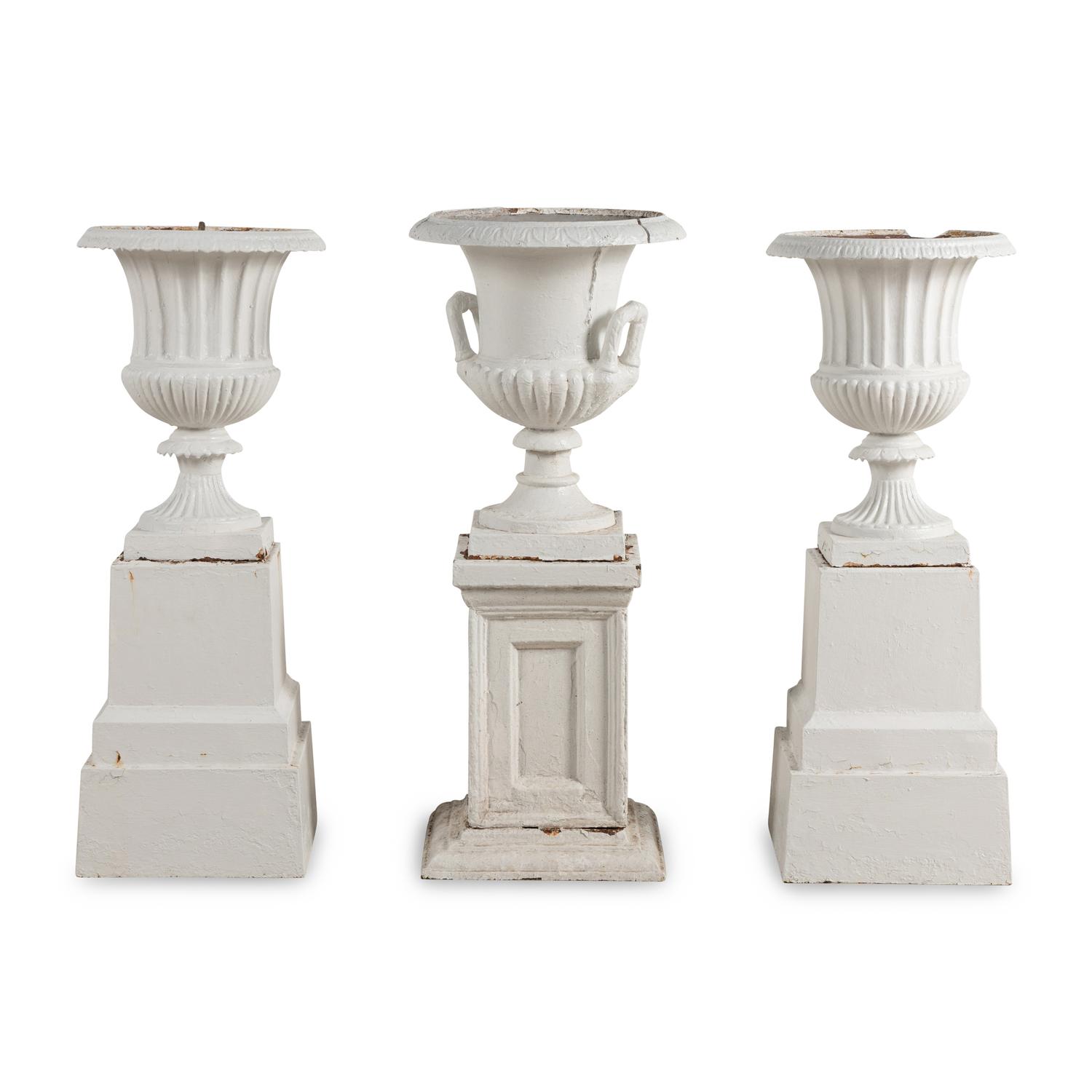 A Set of Three White Painted Iron Garden Urns