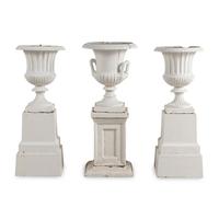 A Set of Three White Painted Iron Garden Urns