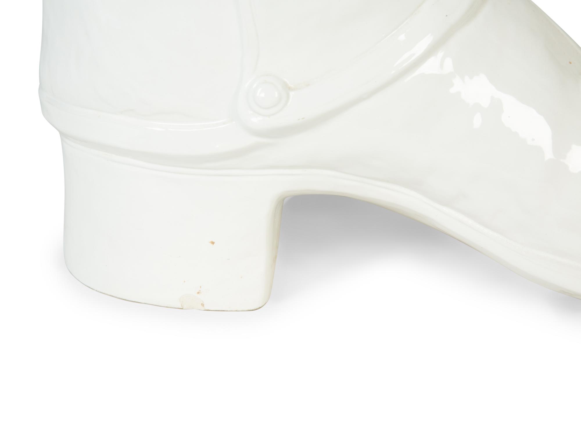 An Italian White-Glazed Earthenware Boot