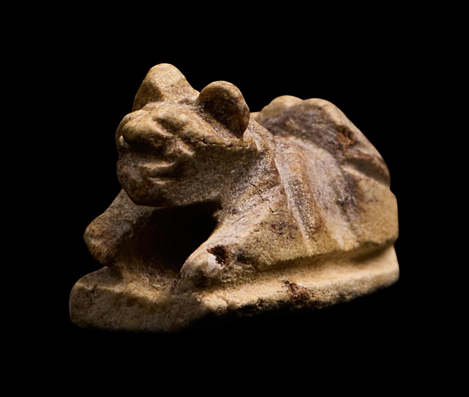 An Egyptian Faience Recumbent Animal