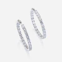 A pair of diamond and fourteen karat white gold earrings