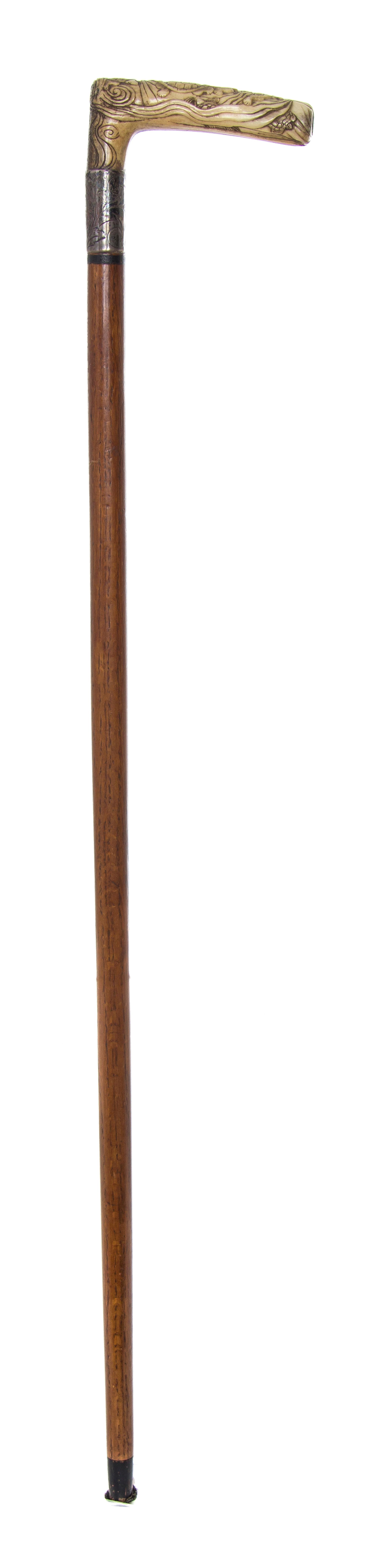 A Japanese Bone Handled Cane, Length of handle 4 1/2 x length overall 31 1/8 inches.