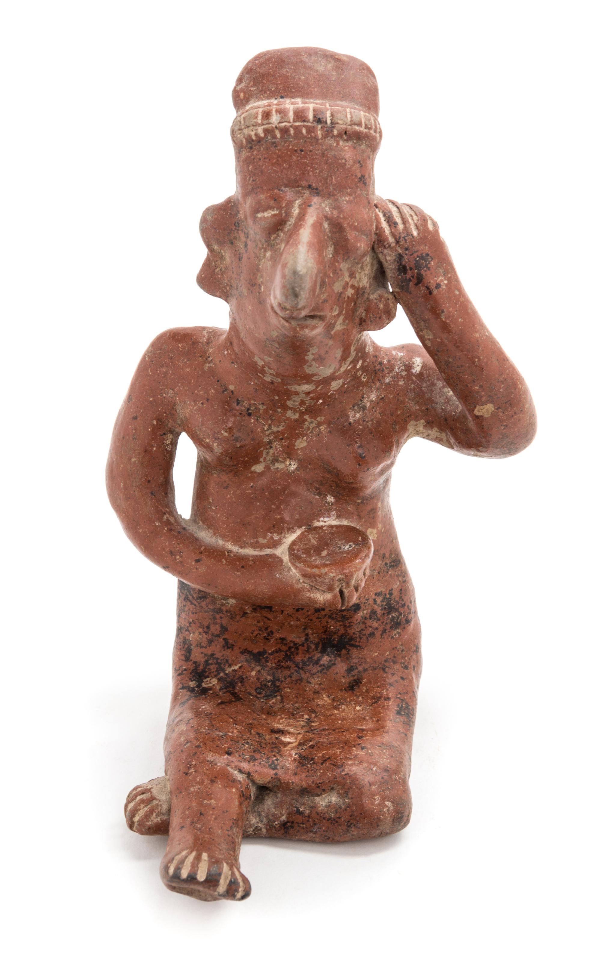 A Mexican Nayarit Polished Earthenware Figure of a Seated Female. Height 7 1/2 x width 5 x depth 6 1/2 inches.
