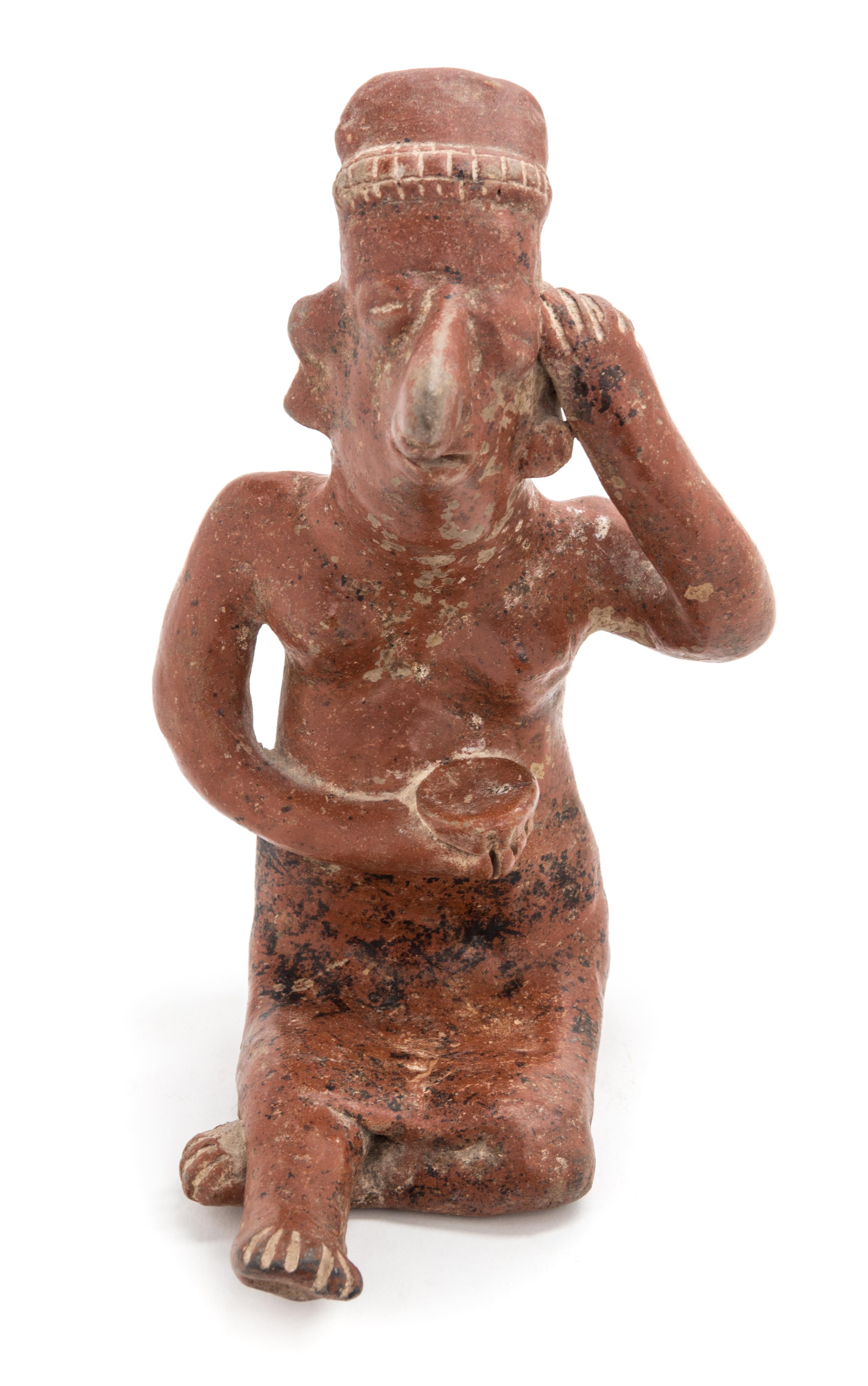A Mexican Nayarit Polished Earthenware Figure of a Seated Female. Height 7 1/2 x width 5 x depth 6 1/2 inches.